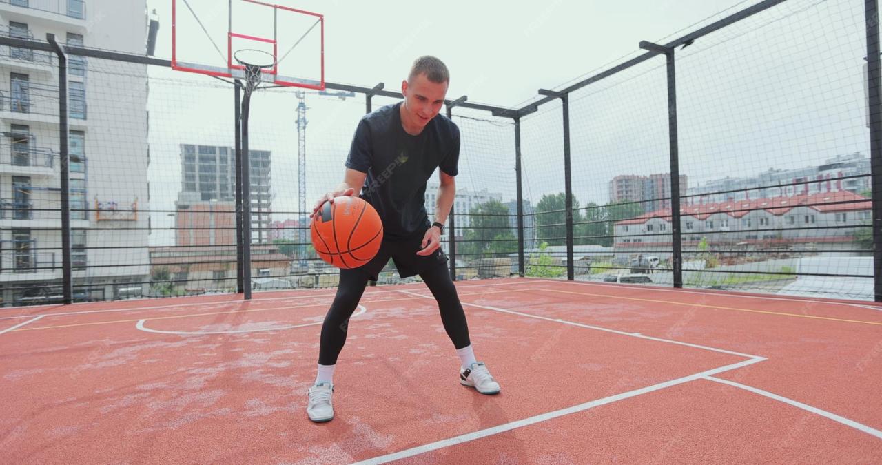 Premium Photo | Male basketball player practicing ball handling skill ...